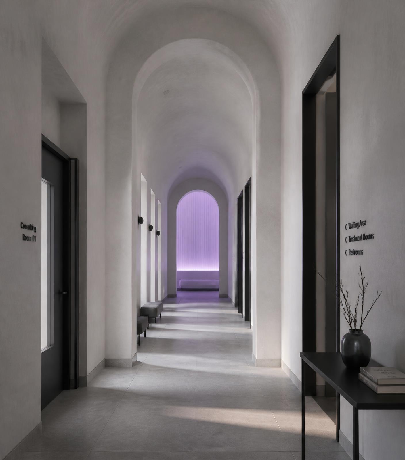 Warmly lit clinic corridor with brass sconces
